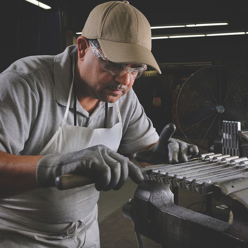 A craftsman in a firearms manufacturing facility