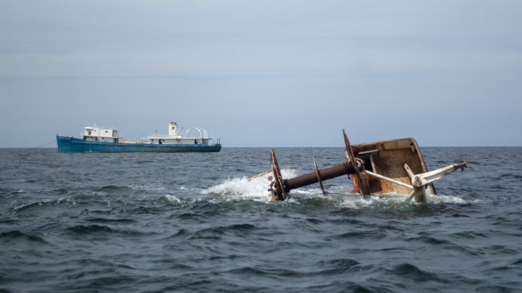 An artificial reef made of a retired ship sinking into the ocean