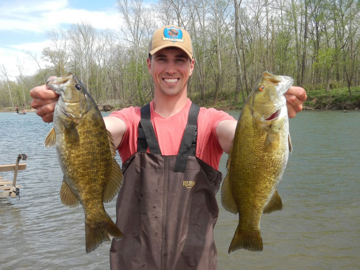 An ODWC biologist holds up a pair of smallmouth bass.