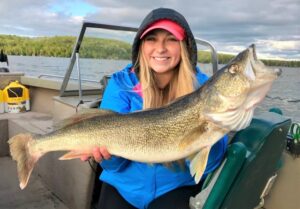 Girl holding a large Walleye fish