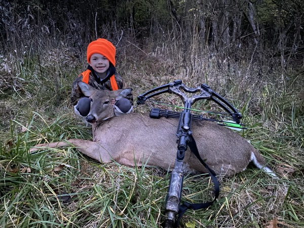 young boy with dead deer