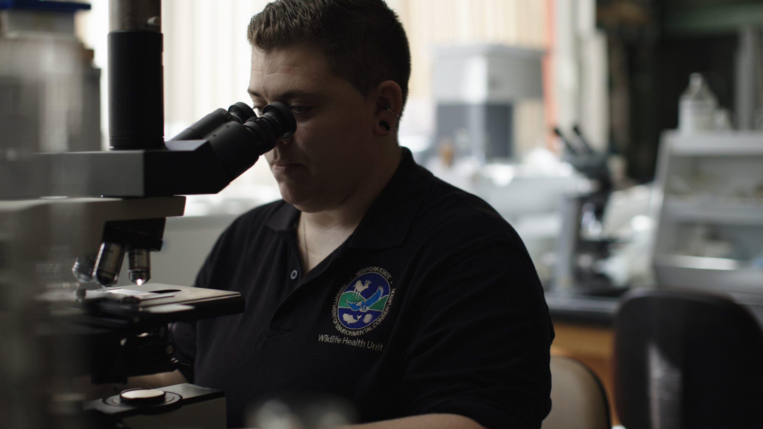 Woman looking through a microscope