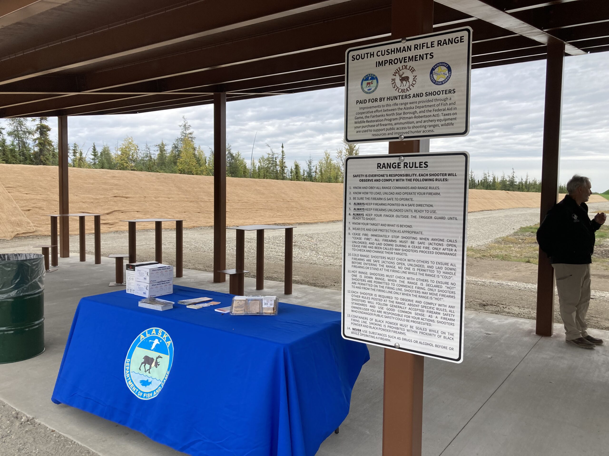 Image of new rifle range with a blue table and two signs