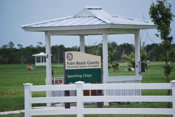 Palm Beach County Sporting Clays Sign in front of white gazebo