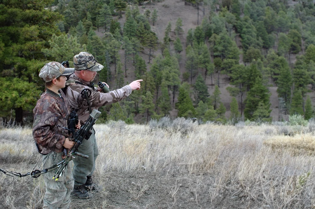 A boy is learning to hunt