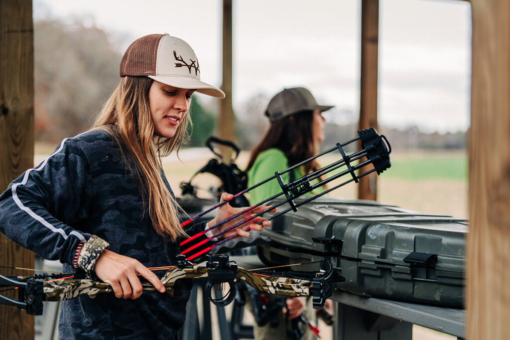 An archery getting her equipment ready at the target range