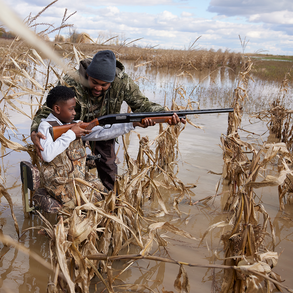 Teaching a young boy to duck hunt