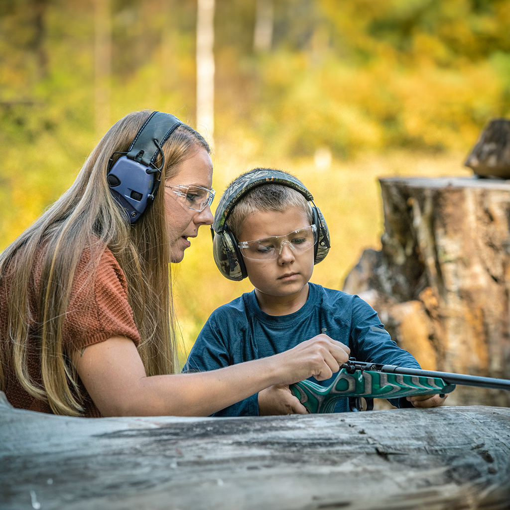 Teaching a young boy shooting skills