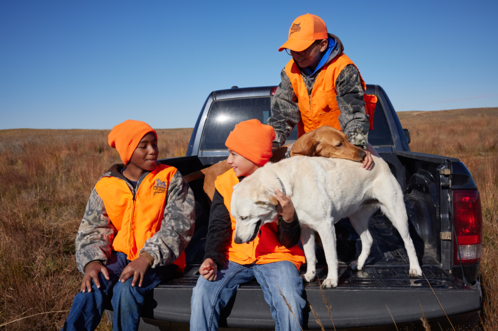 Three Boys Upland Game Hunting With Two Dogs