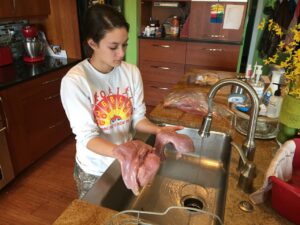 A Young Hunter Prepares Her Wild Turkey For The Table. Craig Springer Usfws