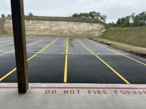 View of range empty firing line with earth berm in the background