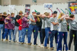 National Archery in the Schools Program participants aim at targets from the shooting line.