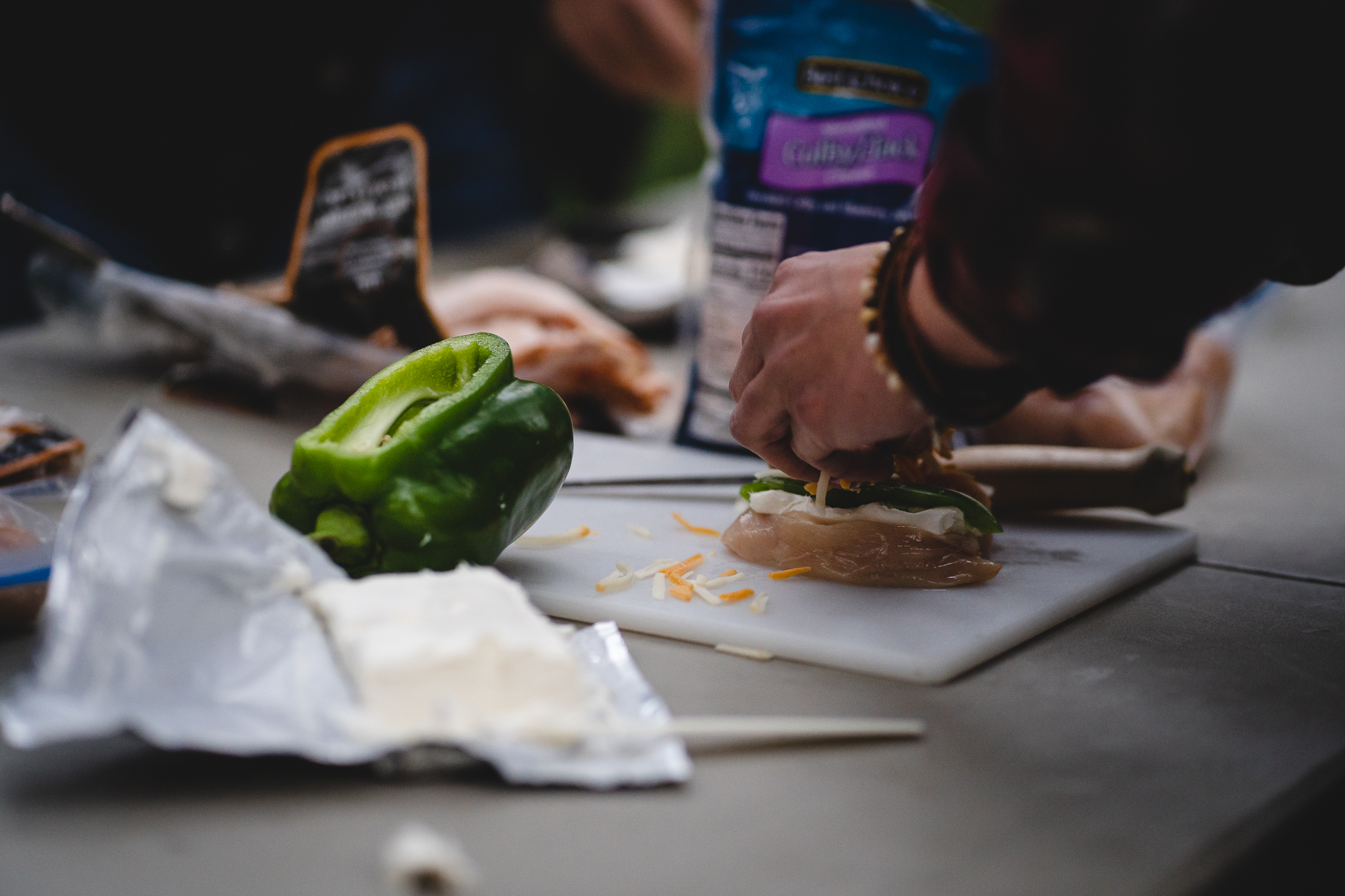 A meal is prepared with raw wild-harvested meat, cheese, and bell pepper.