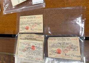 Binder at NCTC holds historic fishing licenses