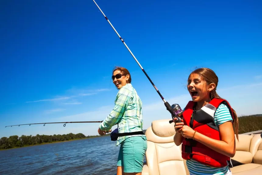 Mom and daughter fishing on a boat