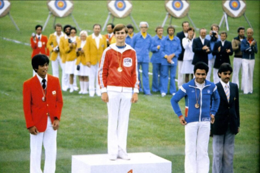 Darrell Pace standing on the Olympic Podium after winning a gold medal