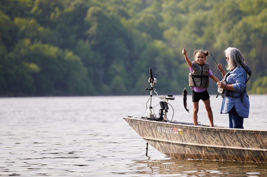 Young girl fishing with an older woman on a boat