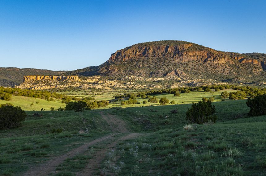 Landscape image of mesas in front of blue sky