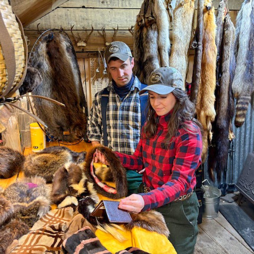 Fur trappers inspecting their goods